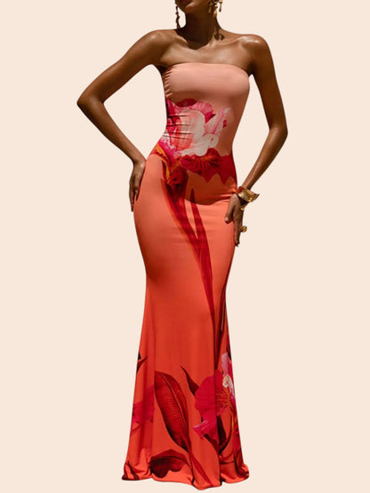 My Store strapless maxi dress in coral with a bold abstract floral print and a flared mermaid hem on a model