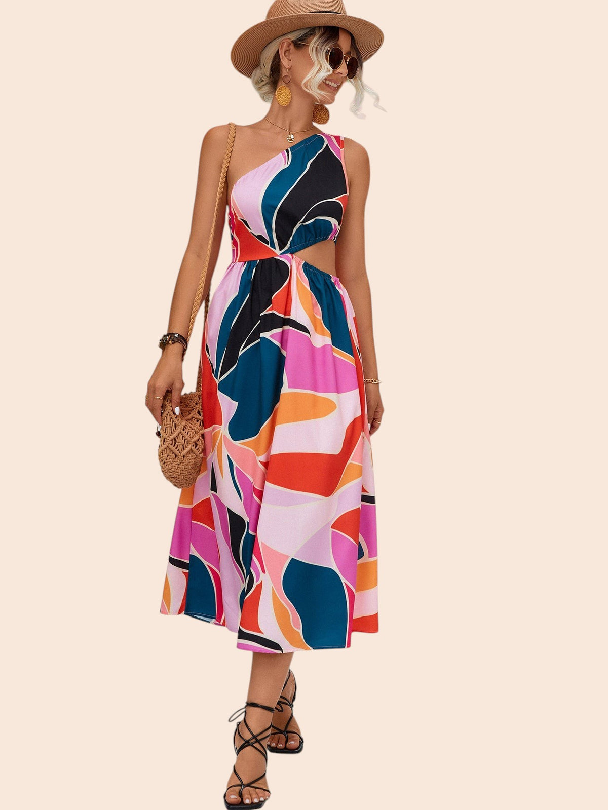 My Store abstract print one-shoulder midi dress with a waist cutout worn by a woman in a sun hat and strappy sandals.