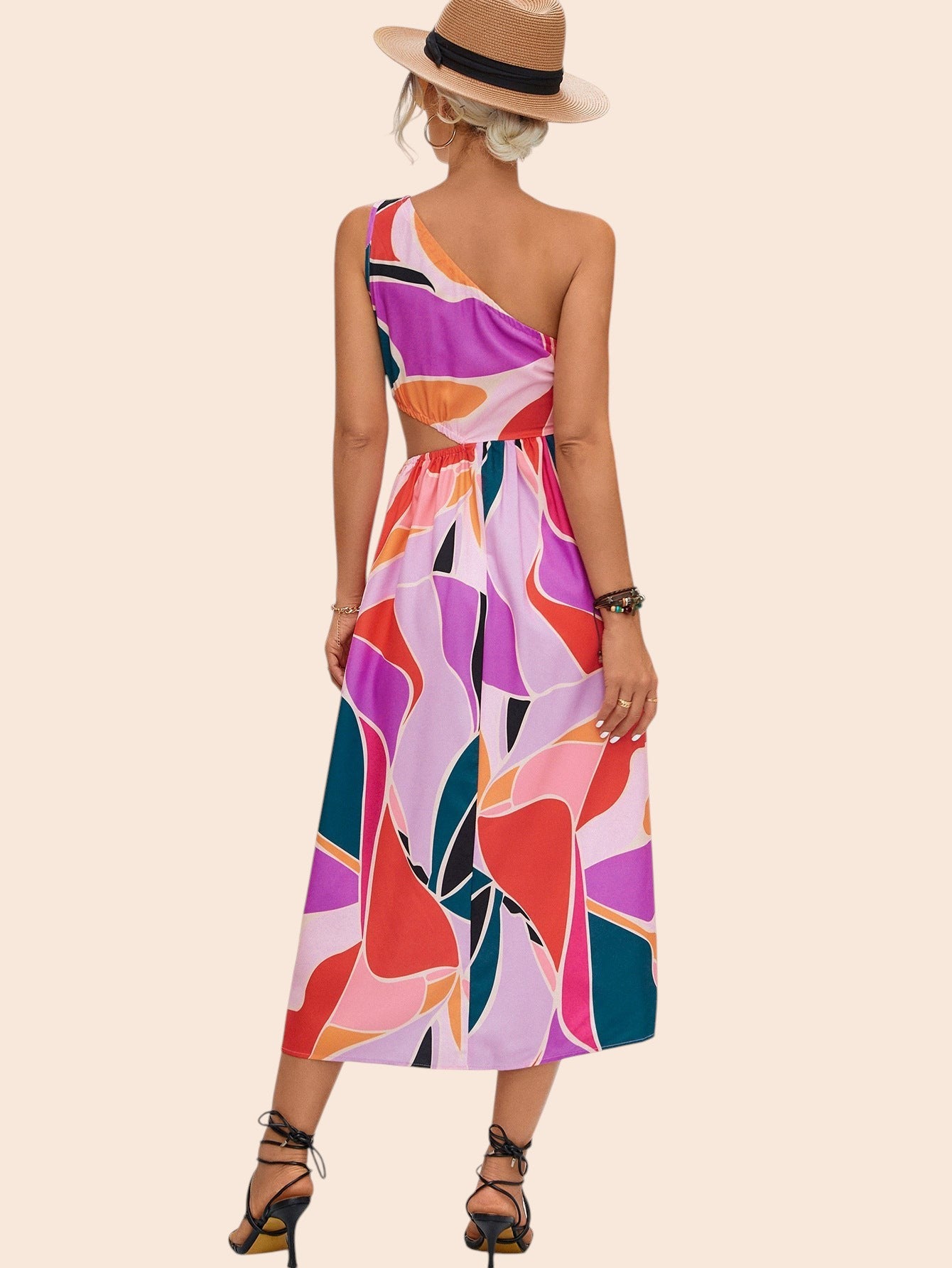 My Store abstract print one-shoulder midi dress with waist cutout worn by a woman in a straw hat on a stone path
