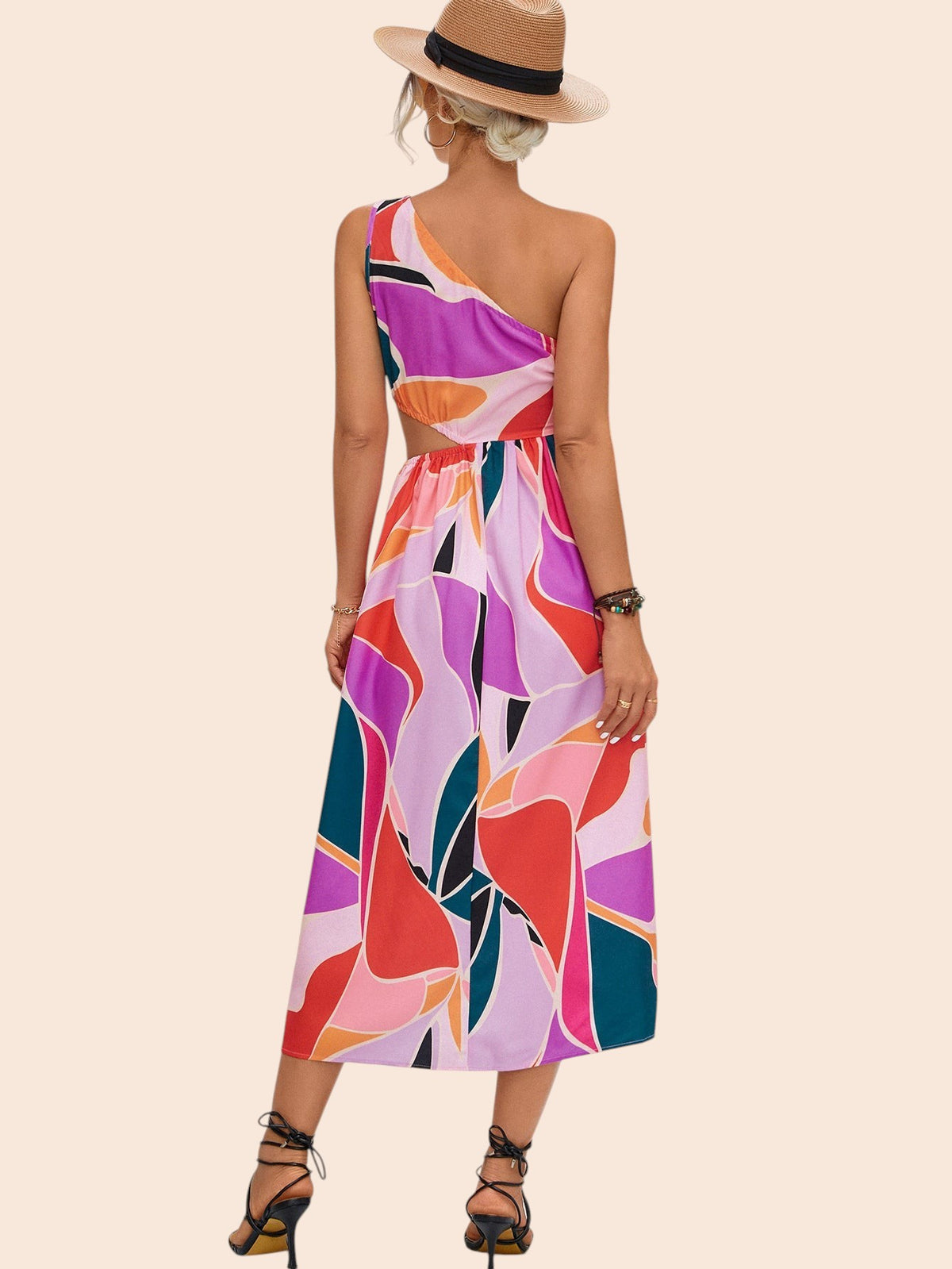 My Store abstract print one-shoulder midi dress with waist cutout worn by a woman in a straw hat on a stone path