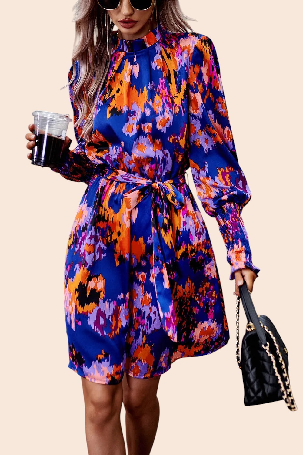 My Store abstract print mini dress with mock neck, voluminous sleeves, and waist tie worn by a woman with sunglasses.