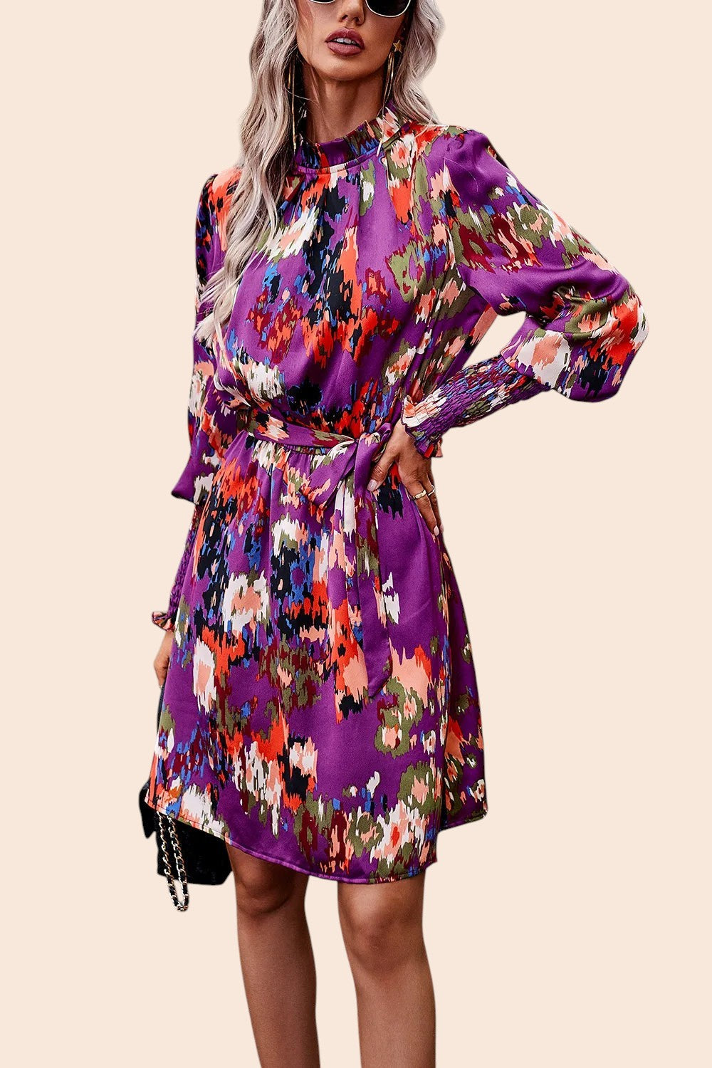 My Store abstract print mini dress with mock neck, long voluminous sleeves, and removable waist tie in purple tones.