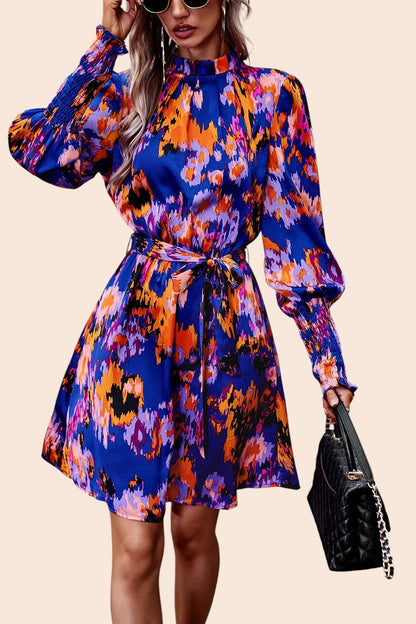 My Store abstract print mini dress with mock neckline, voluminous sleeves, and removable waist tie on a model.