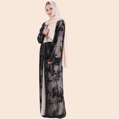 My Store Amira maxi dress in black mesh with floral embroidery and sequins, worn with a beige hijab and inner slip.