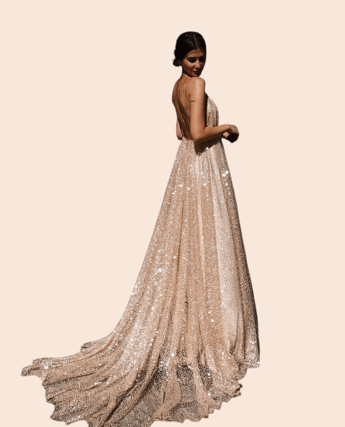 My Store Aurelia gold shimmer maxi gown with a backless design and full floor-length skirt worn on a stone plaza.
