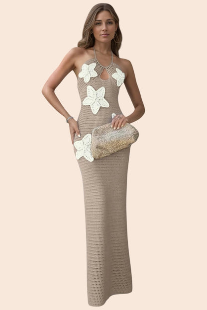 Model wearing a My Store beige crochet maxi dress with white 3D floral appliqués and a halter neckline.