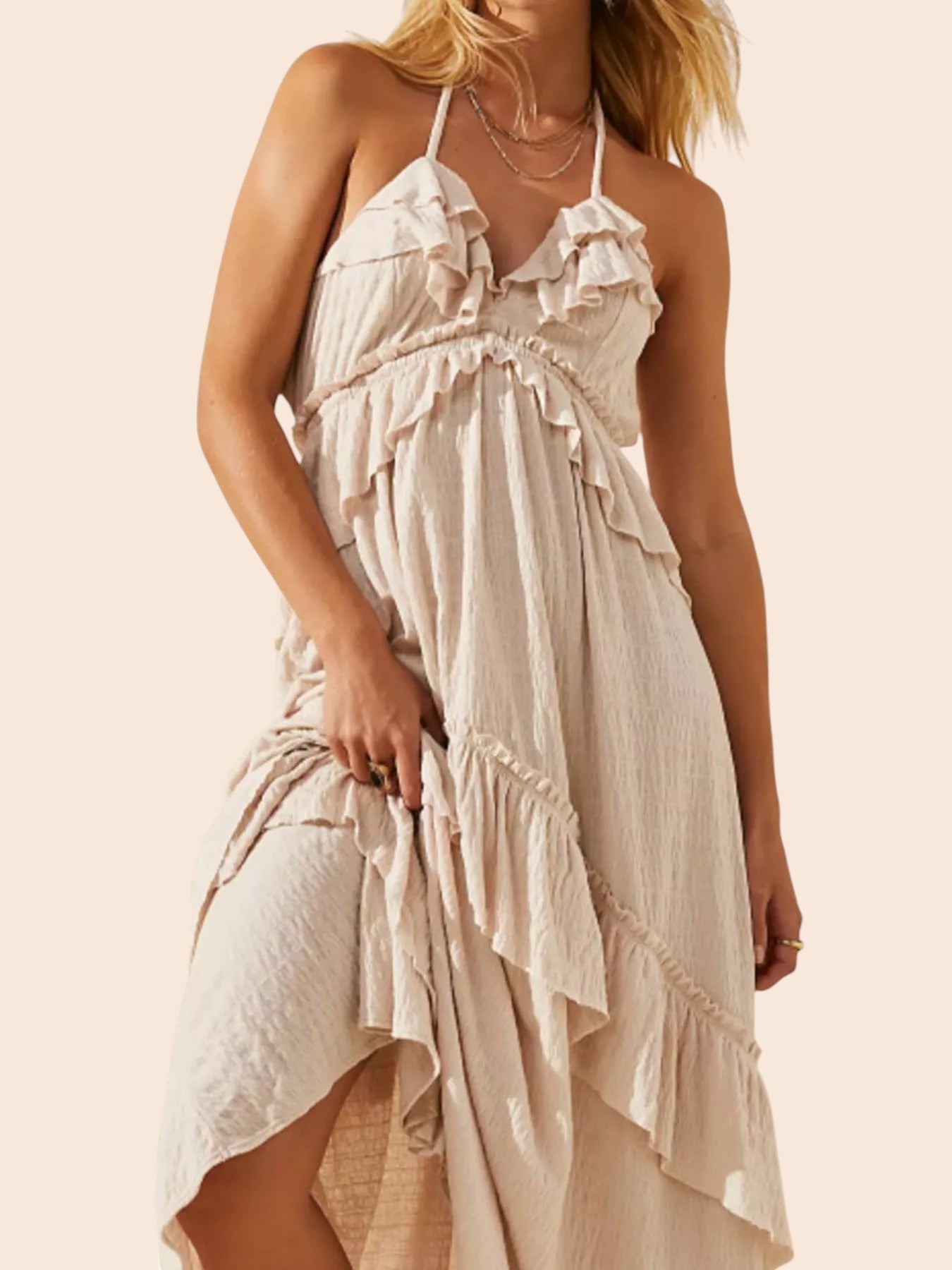 My Store beige ruffled tiered halter maxi dress with an open back and flowing bohemian silhouette on a model