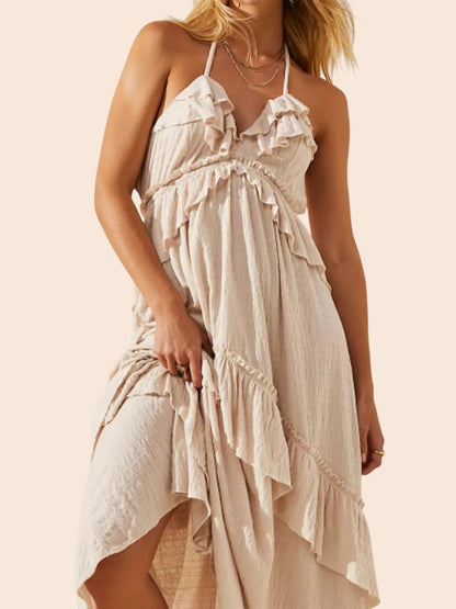 My Store beige ruffled tiered halter maxi dress with an open back and flowing bohemian silhouette on a model