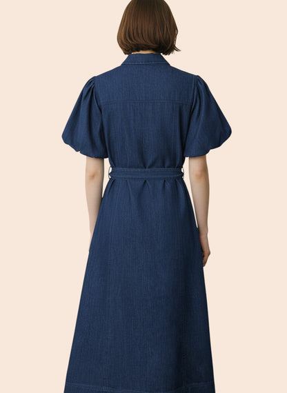 My Store dark wash denim midi dress with puff sleeves, collared neckline, button front, and tie waist. 100% cotton.