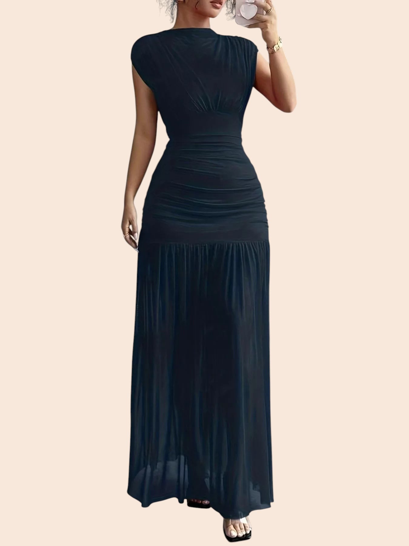 My Store black ruched drop-waist maxi dress with cap sleeves and a flowing skirt on a woman taking a mirror selfie.