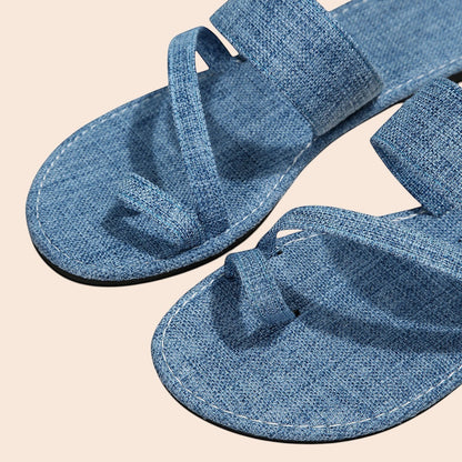 My Store blue denim toe loop sandals with textured crossover straps and white stitching. Flat sole, slip-on style.