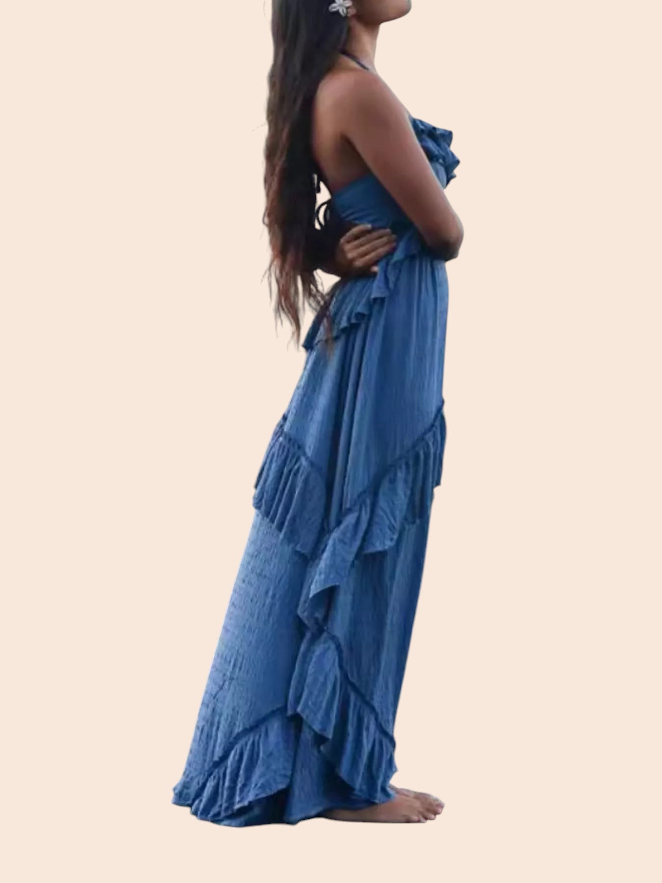 My Store blue ruffled tiered halter maxi dress worn by a woman standing on rocky beach at sunset