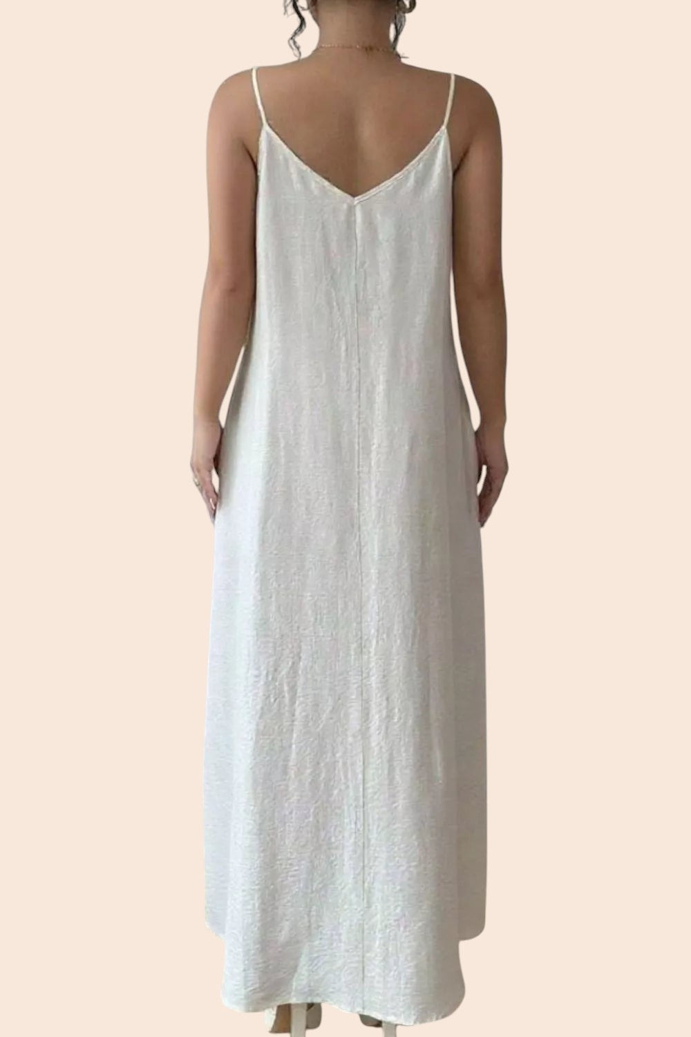 Back view of a My Store cream textured maxi dress with a V-neckline and spaghetti straps on a model
