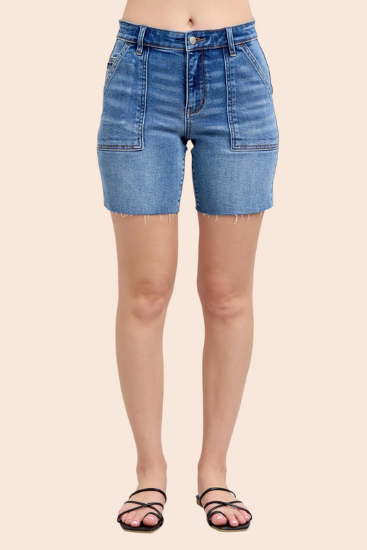 My Store medium-wash denim Bermuda shorts with utility patch pockets, mid-rise waist, and raw hem on a model