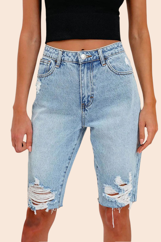 My Store high-rise light-wash denim Bermuda shorts with distressed detailing and a raw frayed hem on a model.