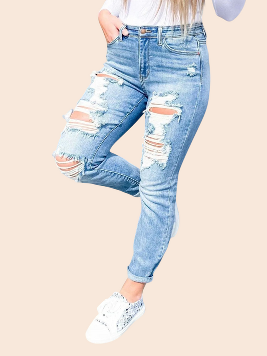 My Store light-wash high-waisted skinny jeans with heavy distressed knee detailing worn with white sneakers