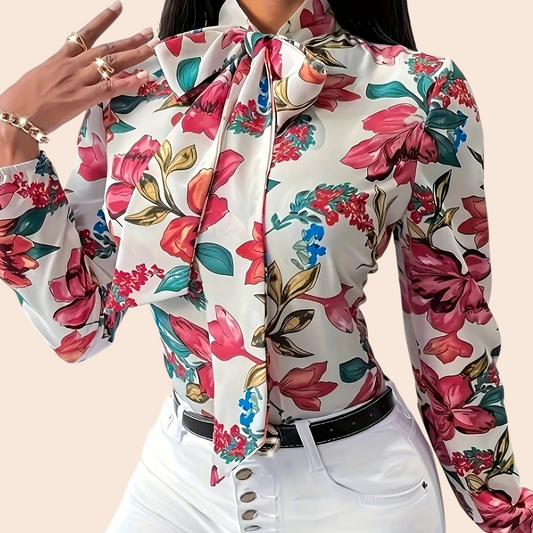 My Store floral bow-tie blouse with long sleeves and vibrant pink and green botanical print on a cream background