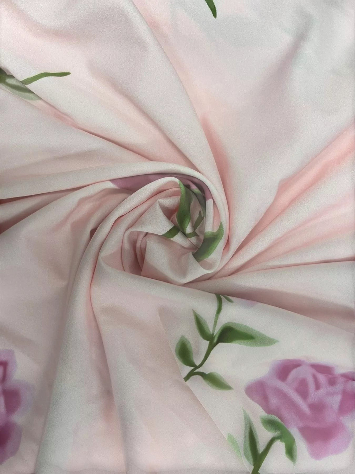 My Store floral print fabric in soft pink with green leaves and purple roses, showing a close-up swirl texture.