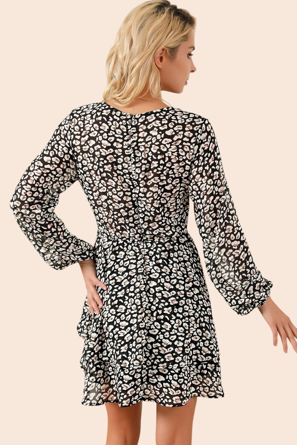 Back view of a My Store floral mini dress with long balloon sleeves and a tiered ruffle skirt on a blonde model.
