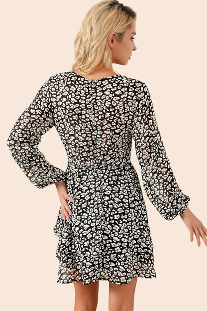 Back view of a My Store floral mini dress with long balloon sleeves and a tiered ruffle skirt on a blonde model.