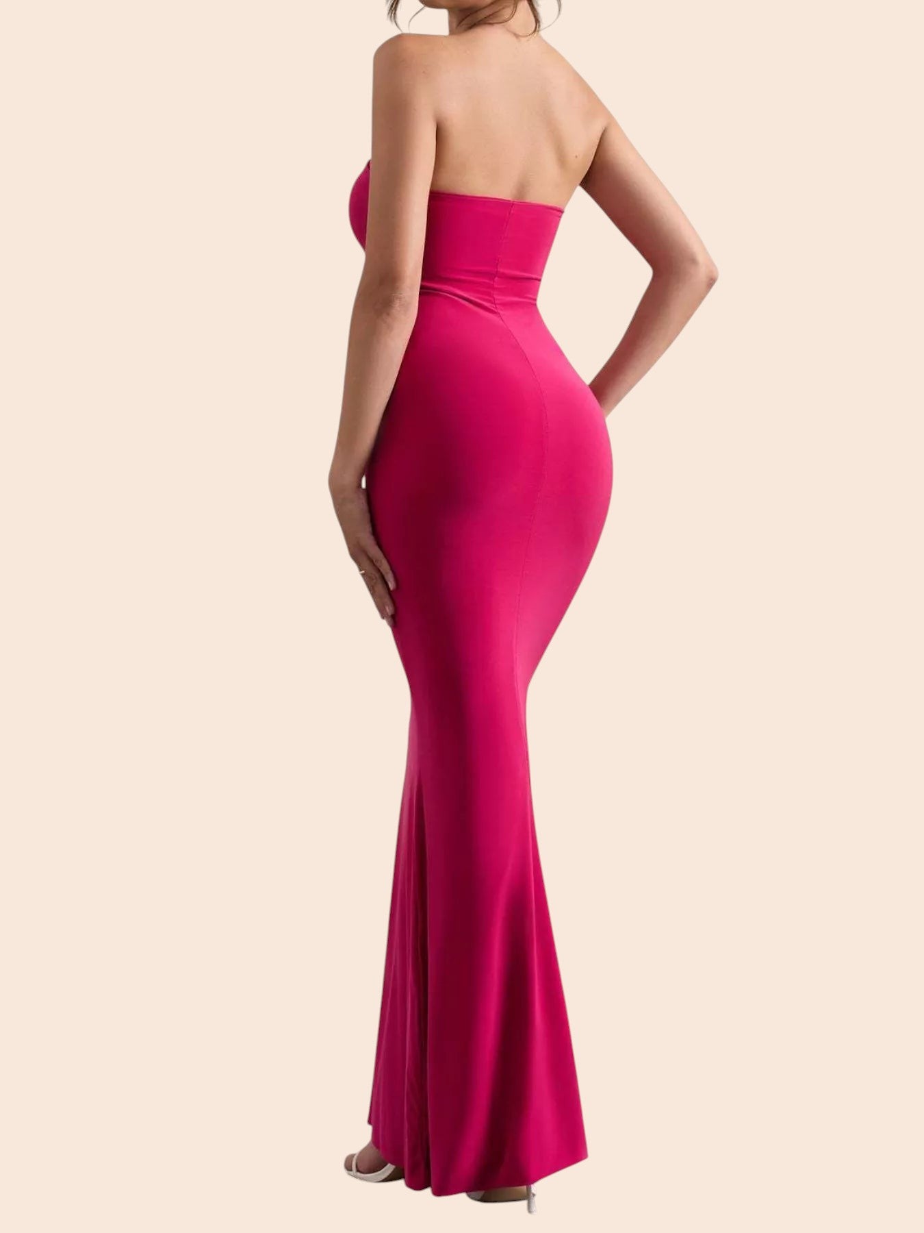 My Store strapless fuchsia pink mermaid maxi dress with a curve-enhancing silhouette and flared hem, back view.