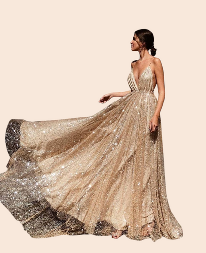 My Store Aurelia gold shimmer plunge maxi gown with a deep V-neckline and full flowing skirt worn outdoors