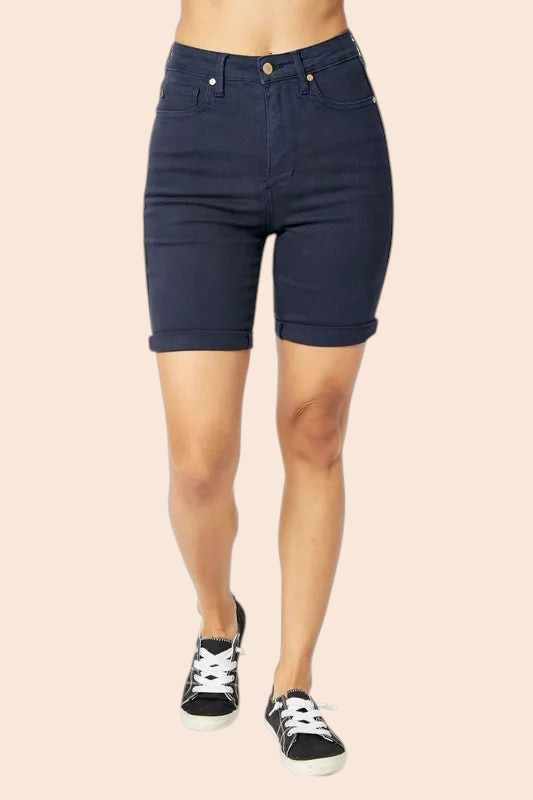 My Store high-rise dark wash denim Bermuda shorts with tummy control and cuffed hems worn with black sneakers.