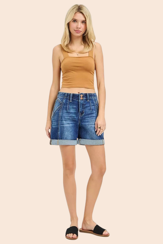 Model wearing My Store high-rise denim shorts with seamed detailing and rolled cuffs paired with a tan tank top