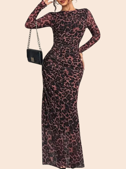 My Store leopard print long sleeve maxi dress in semi-sheer mesh with ruched detailing on a model holding a handbag.