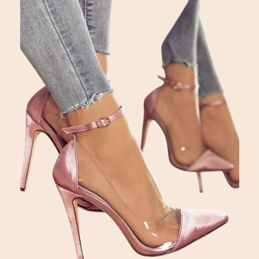 My Store pink pointed-toe stiletto heels with transparent side panels and an adjustable ankle strap worn on feet.