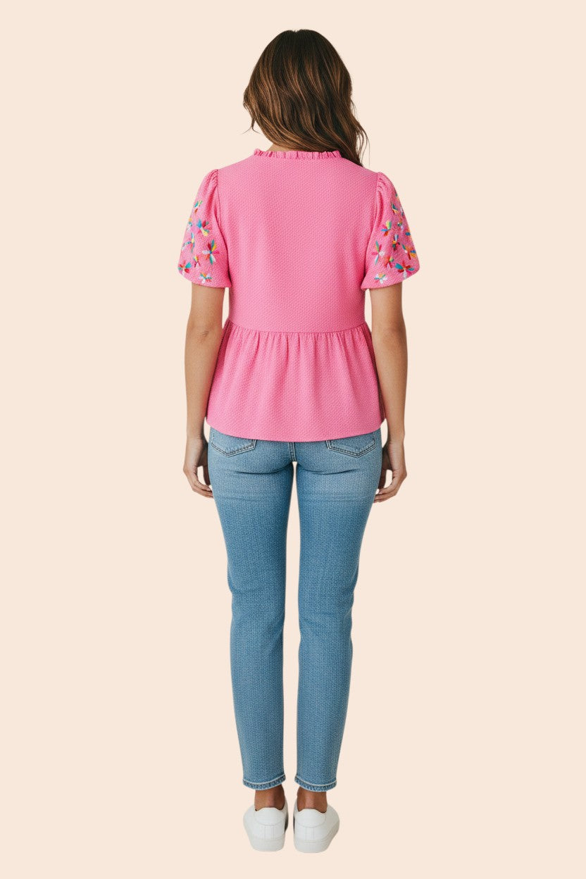 My Store pink textured blouse with embroidered flower detail on puff sleeves and frill neckline. 100% polyester.