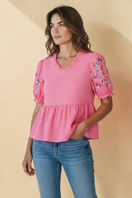My Store pink textured polyester blouse with frilled V-neck, puff sleeves, and colorful floral embroidery.