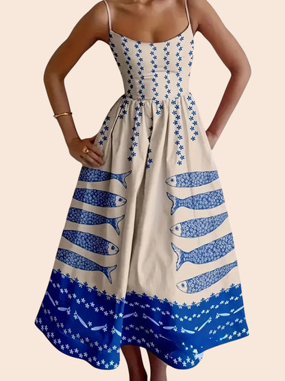 My Store midi dress with blue sardine graphic print, smocked bodice, and spaghetti straps on a cream background.