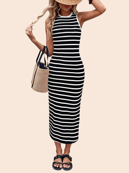 My Store sleeveless black and white striped bodycon midi dress worn with a straw hat, woven bag, and flat sandals.