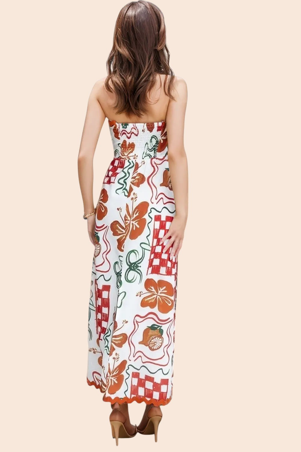 My Store strapless maxi dress with a colourful tile and floral print, worn by a woman standing by a resort pool.
