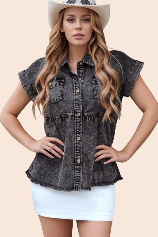 Model wearing a My Store washed black denim babydoll top with cap sleeves, button front, and raw-edge hem.