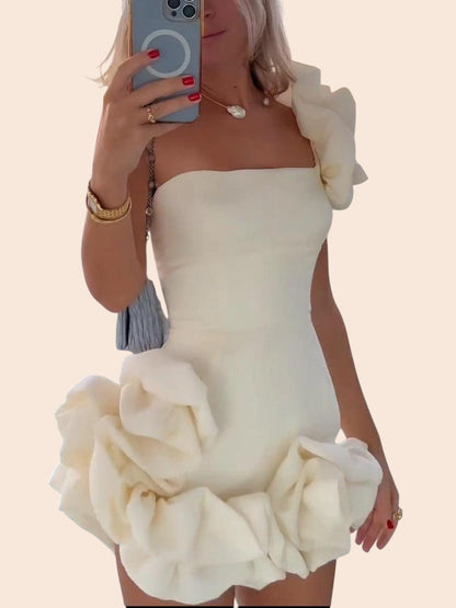 My Store white one-shoulder mini dress featuring dramatic 3D floral accents on the shoulder and sculpted hem.