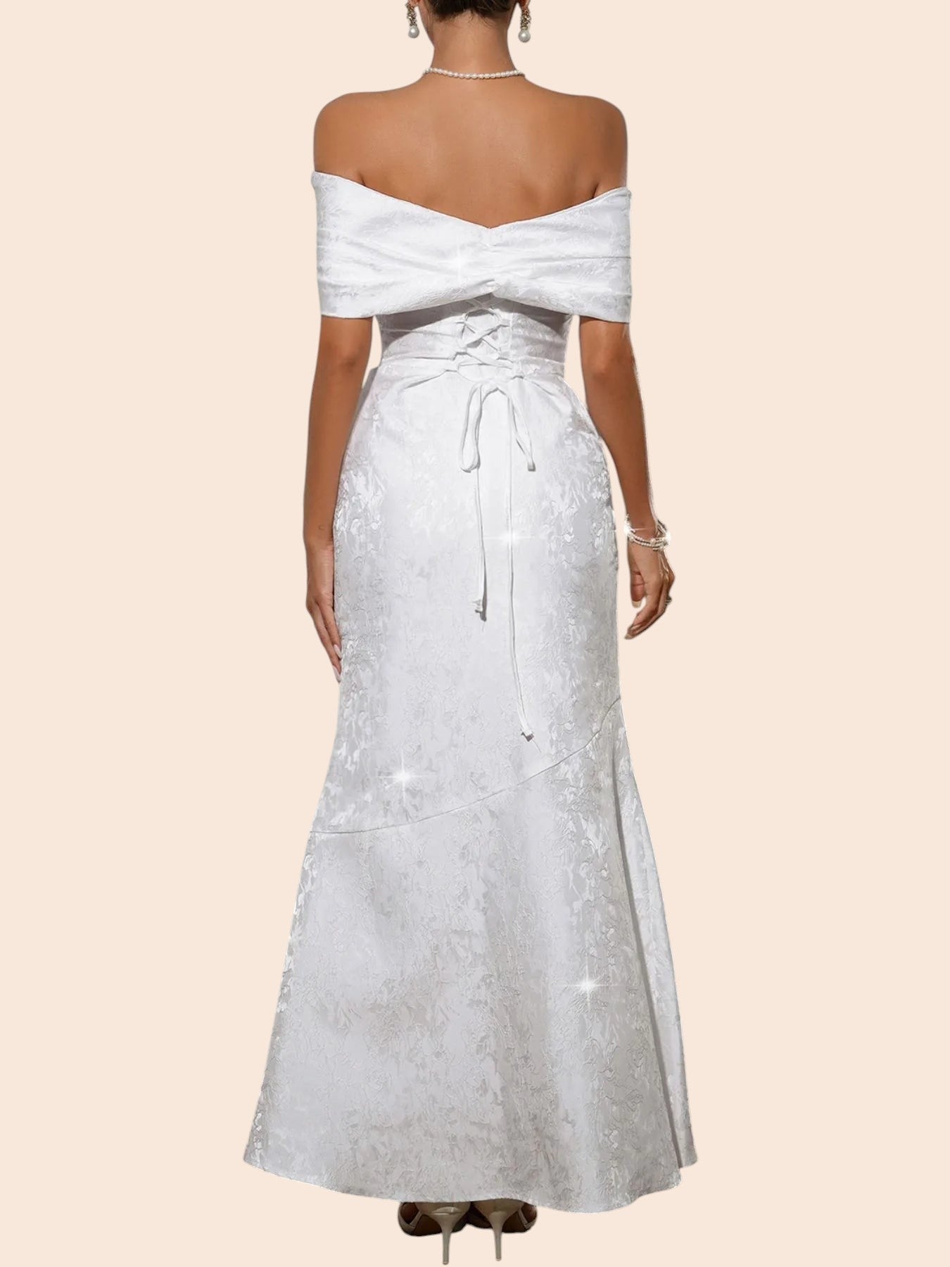 Back view of a My Store white off-shoulder maxi dress with a statement bow, lace-up bodice, and textured fabric.