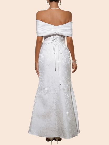 Back view of a My Store white off-shoulder maxi dress with a statement bow, lace-up bodice, and textured fabric.