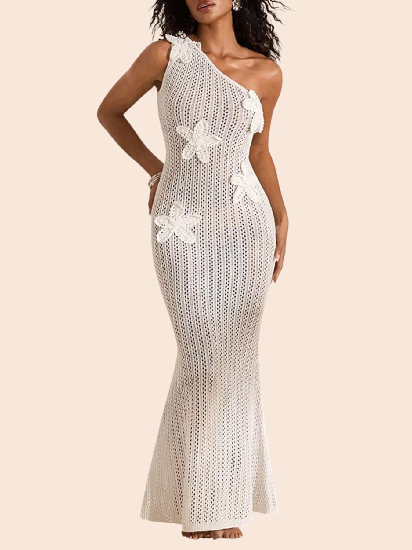 My Store white crochet maxi dress with one-shoulder neckline and dimensional floral appliqué details on a sandy beach