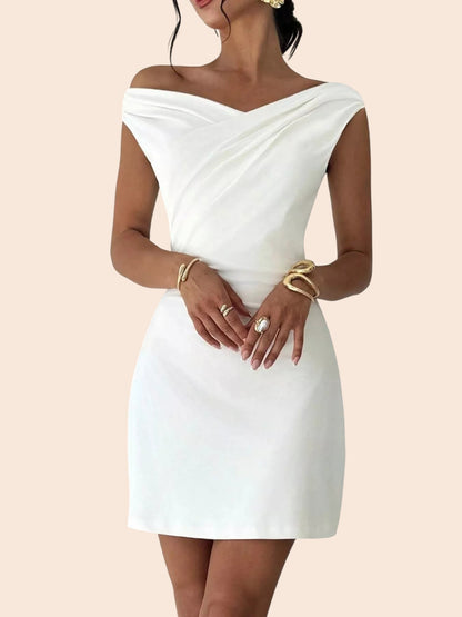 My Store white off-shoulder mini dress with a draped neckline and A-line silhouette, styled with gold jewelry.