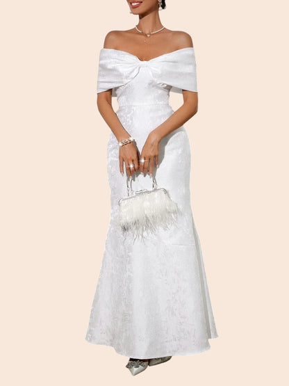 My Store white off-shoulder maxi dress with a statement bow bodice, lace texture, and elegant flared hem.