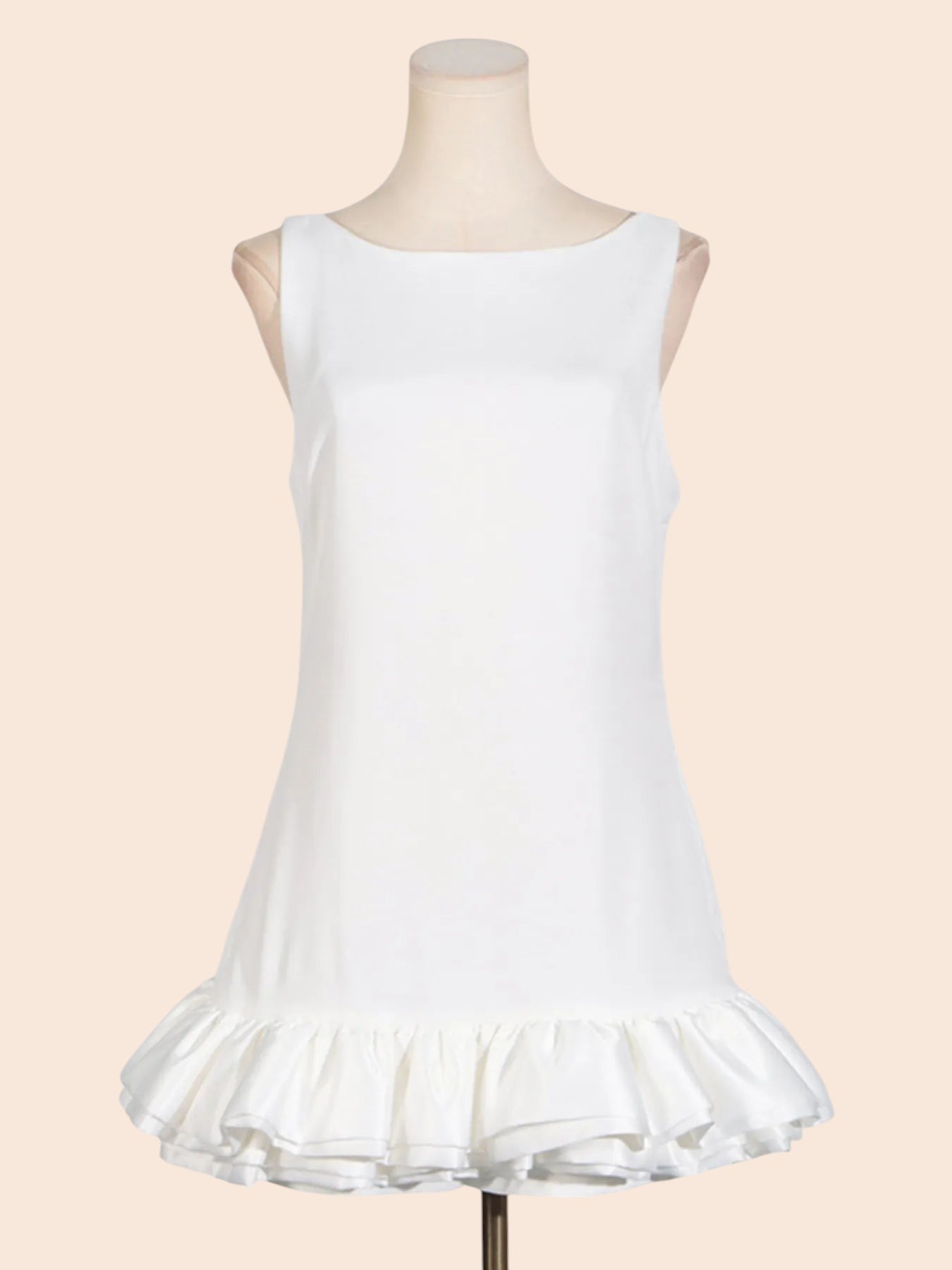 My Store white sleeveless mini dress with a round neckline and a sculpted layered ruffle hem on a mannequin