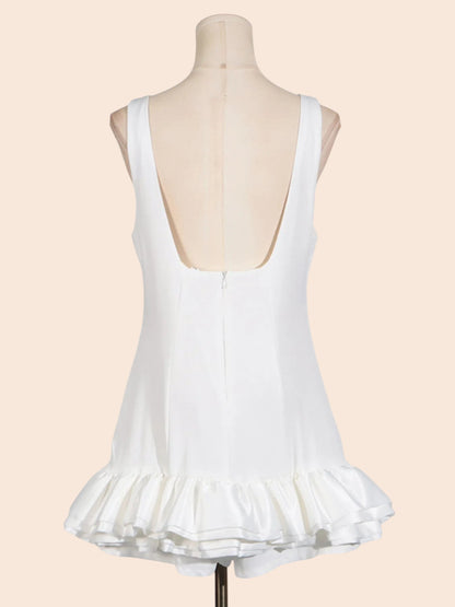 My Store white sleeveless mini dress with a low back and a sculpted layered ruffle hem on a mannequin