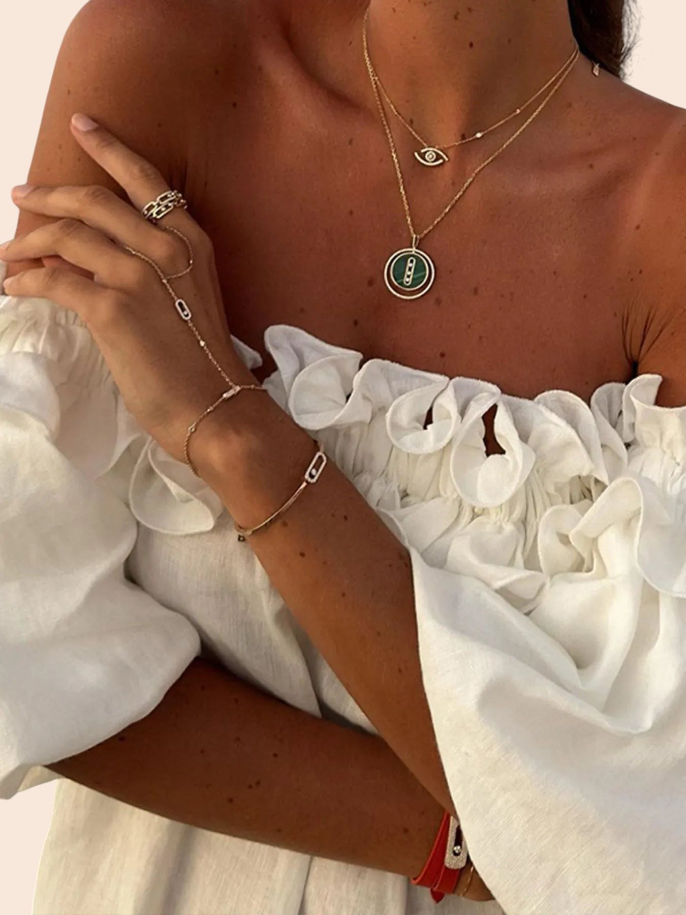 My Store white off-shoulder maxi dress with ruffled neckline and voluminous sleeves worn with gold layered jewelry