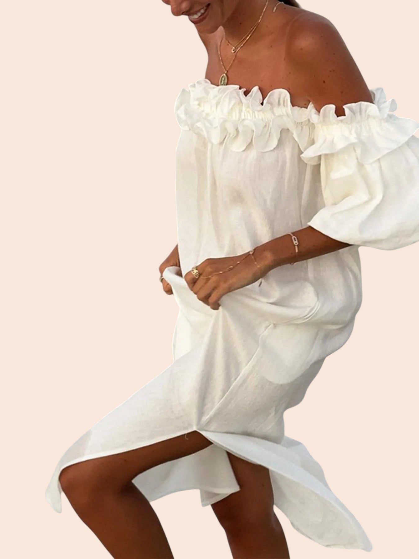My Store white off-shoulder maxi dress with ruffled neckline, voluminous sleeves, and side slit on a smiling woman