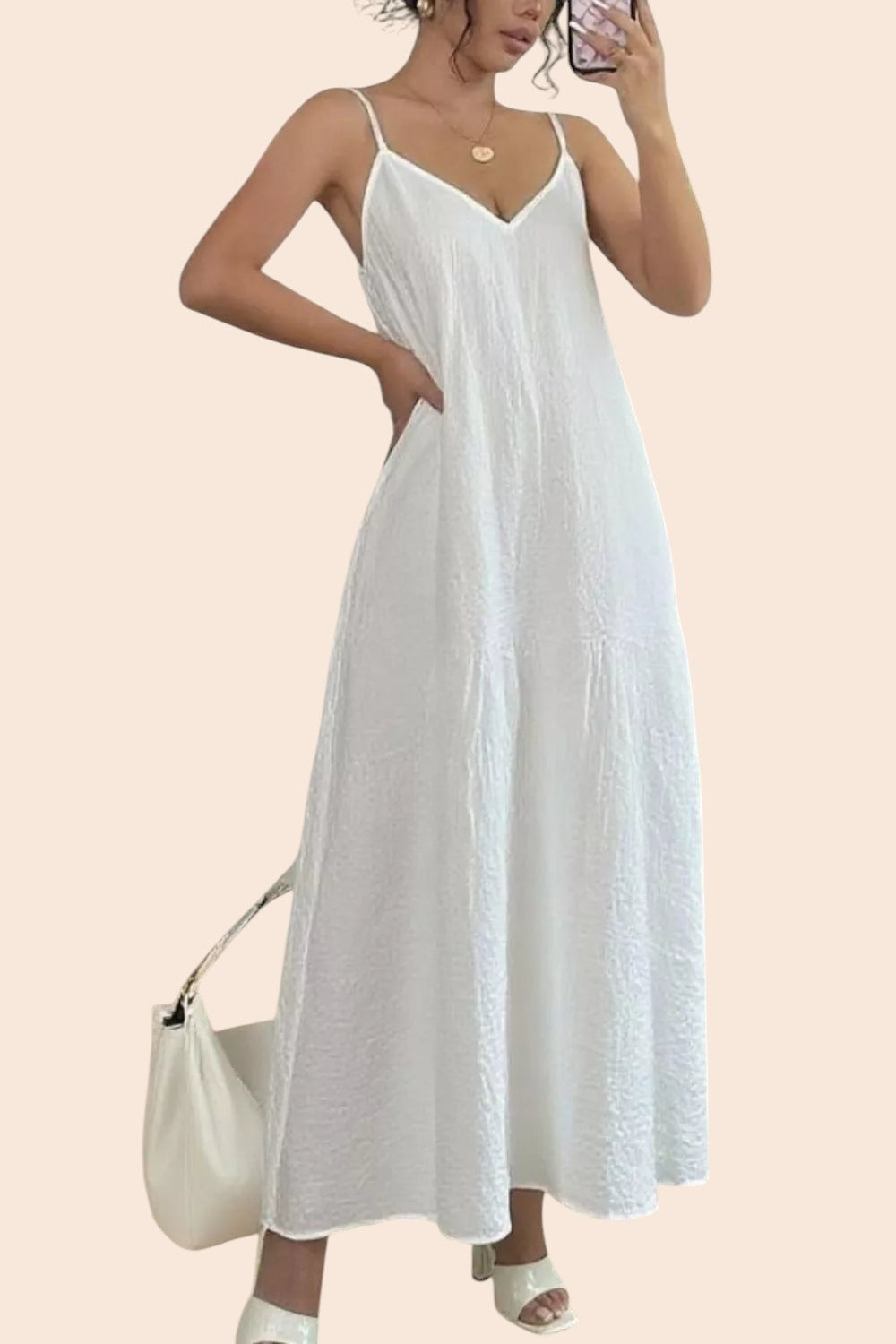 My Store white textured V-neck maxi dress with spaghetti straps worn by a woman holding a handbag