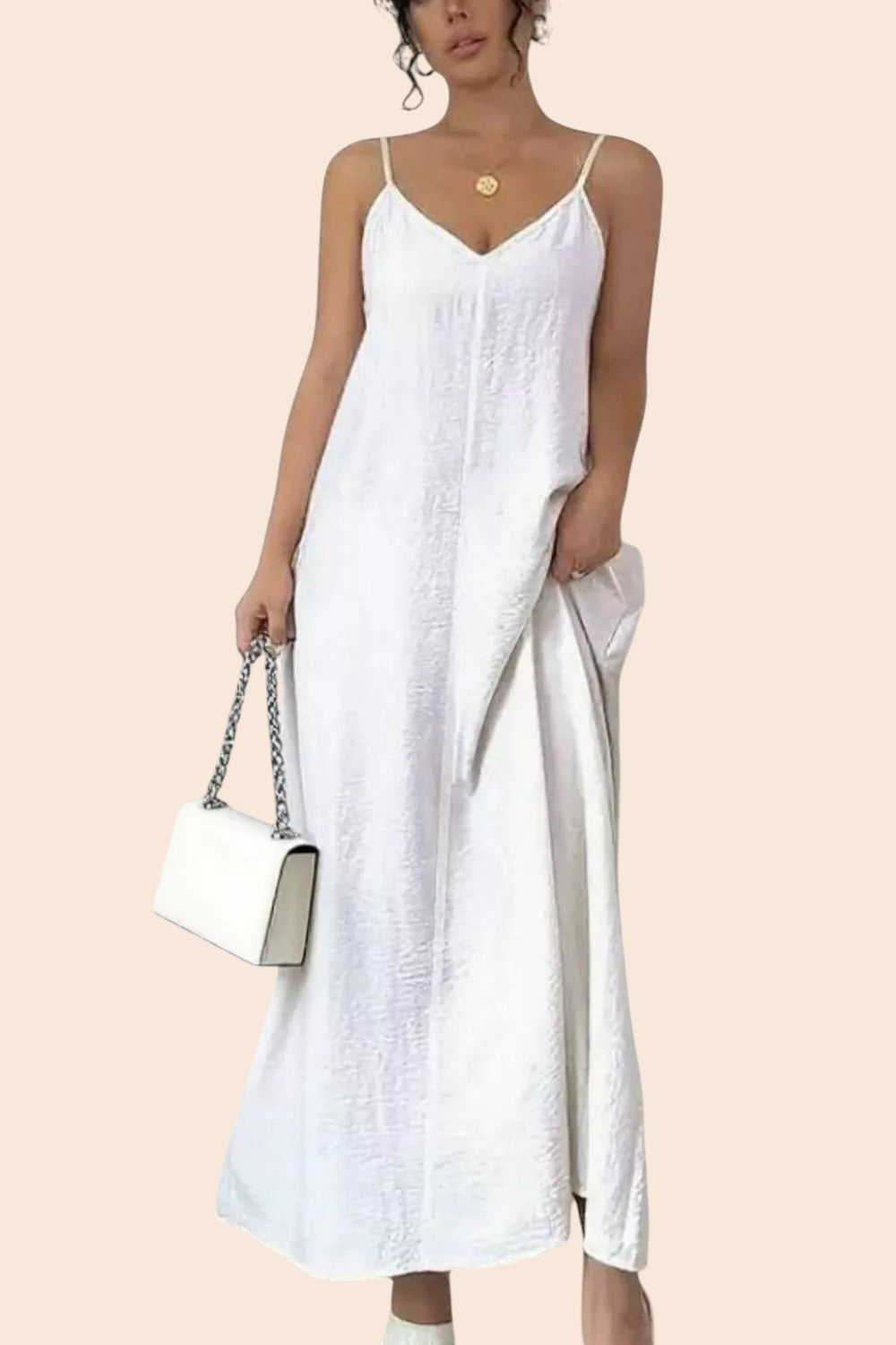 My Store white textured V-neck maxi dress with spaghetti straps worn by a model holding a white chain-strap handbag