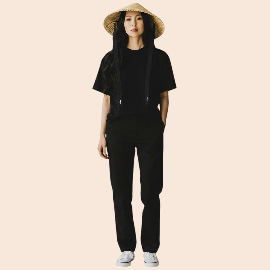 My Store wide brim straw sun hat with black ribbon ties, worn by a woman with long dark hair.